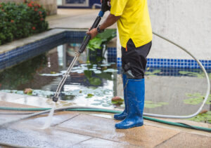Man high pressure cleaning a surface