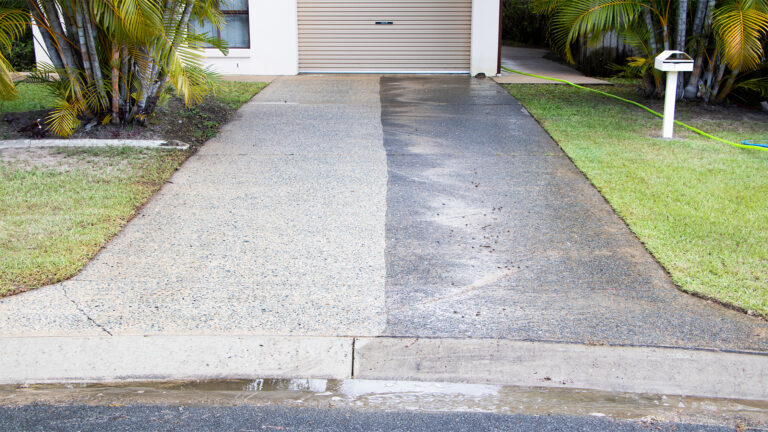 House Driveway during pressure cleaning. Half of the driveway has been cleaned half hasn't.